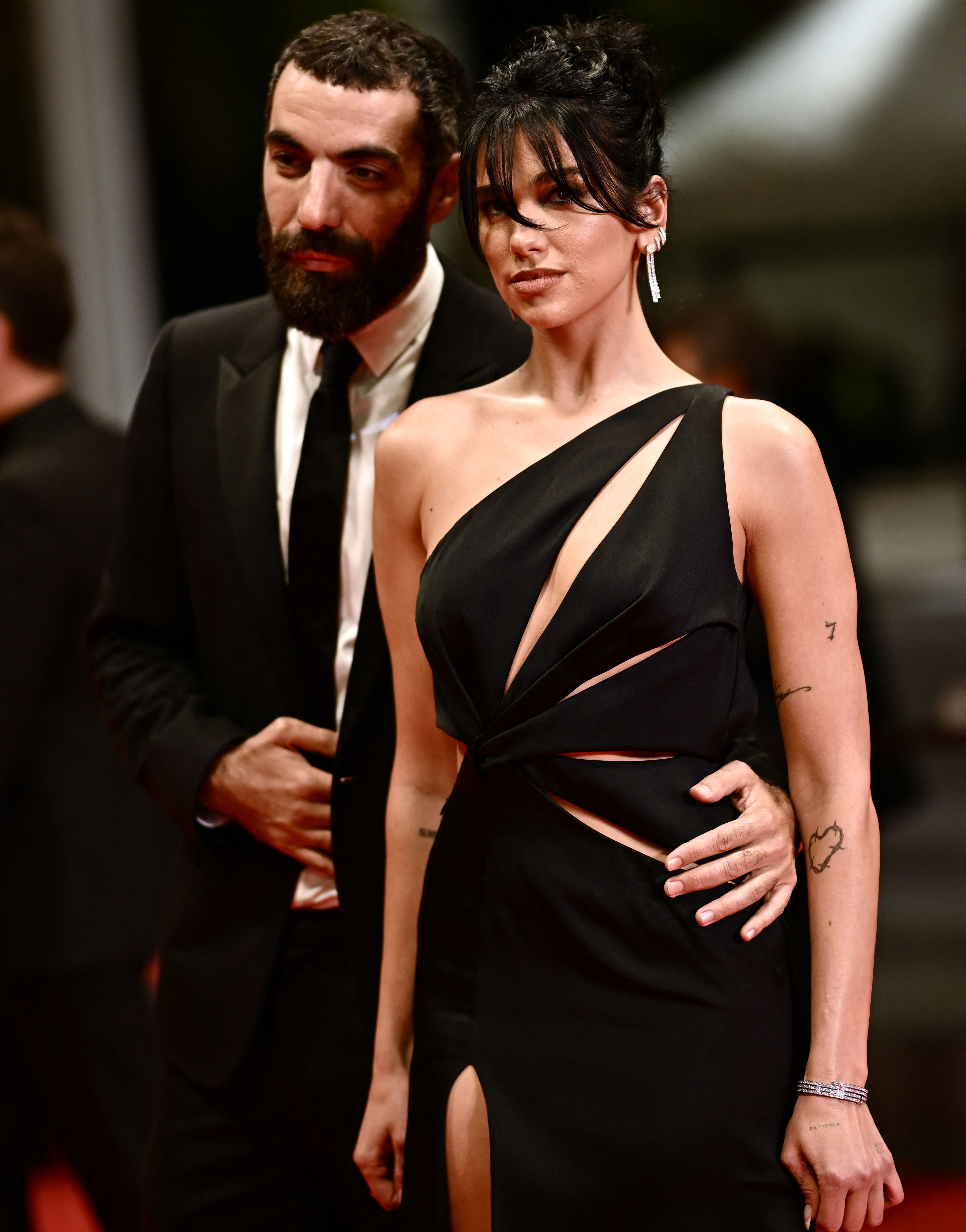 French director Romain Gavras (L) and British singer and model Dua Lipa arrive for the screening of the film "Omar la Fraise" (The King of Algiers) during the 76th edition of the Cannes Film Festival in Cannes, southern France, on May 20, 2023. (Photo by LOIC VENANCE / AFP) (Photo by LOIC VENANCE/AFP via Getty Images)